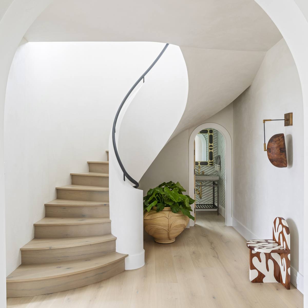 Sculptural custom staircase, an example of finish craftsmanship in a modern Lowcountry home