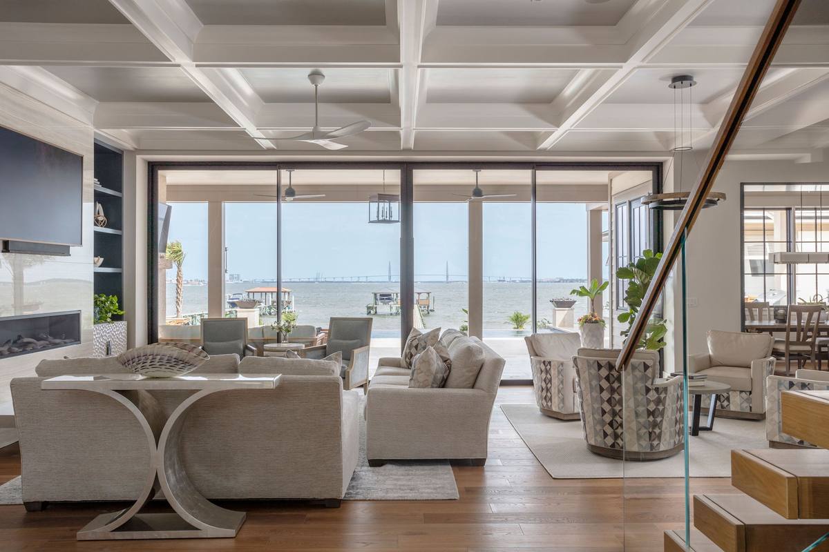 Living room lit from three sides with large windows