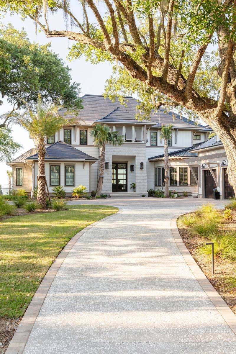 Tree-lined walkway approaching the home