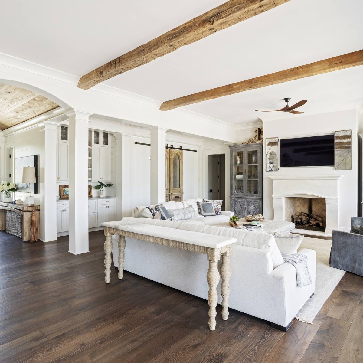 Living room with exposed wood beams in a custom Daniel Island home