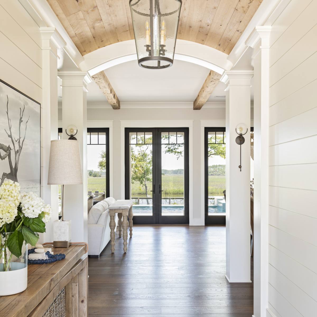 Barrel-vaulted wood ceiling opening to pool views