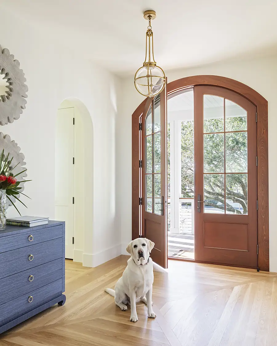 Arched wood front door standing open on move-in day