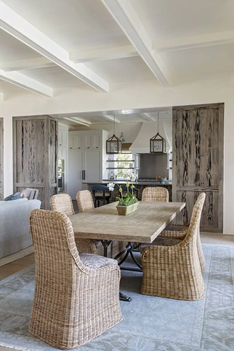 Open-concept waterfront dining and kitchen with reclaimed pecky cypress door, Sullivan's Island
