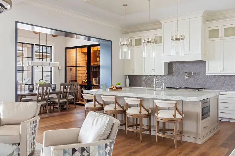 Kitchen with marble-topped island and wine room beyond