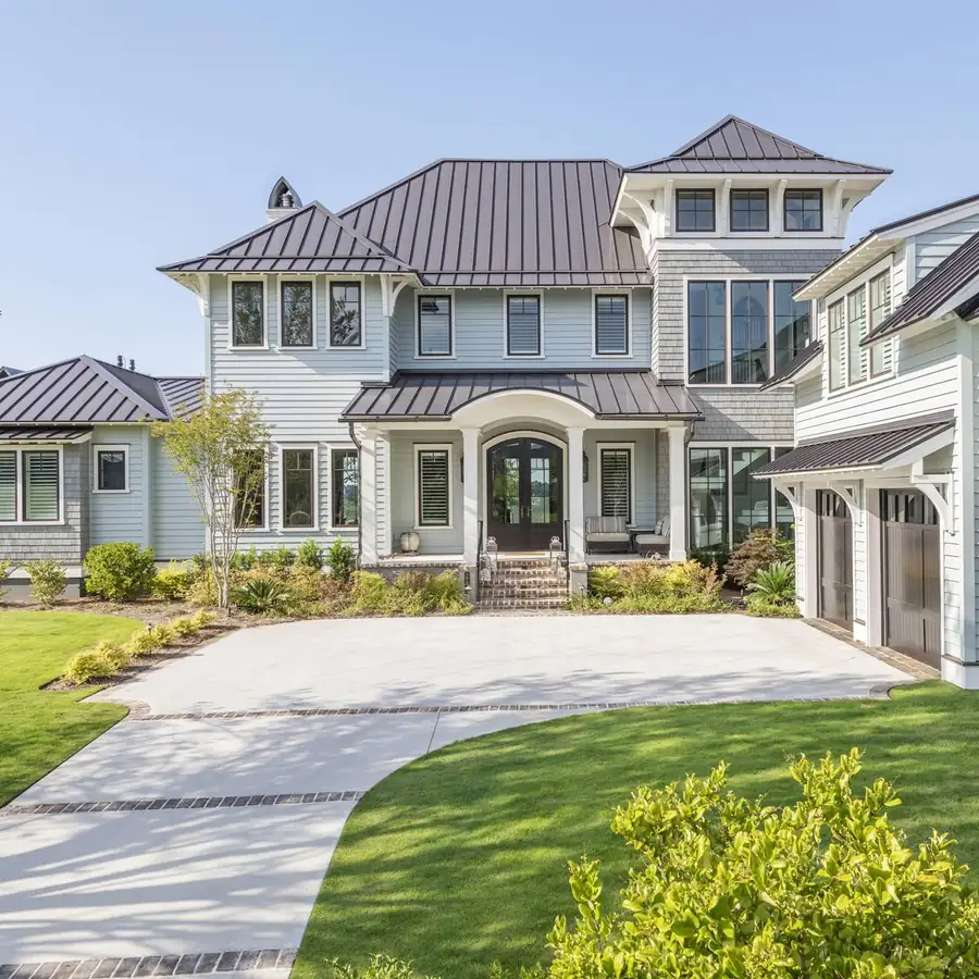 Front exterior with layered rooflines and gas lanterns, Daniel Island custom home